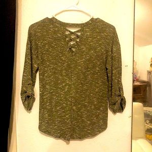 It’s an army sweater with x cut outs in the back and he’s button sleeves.